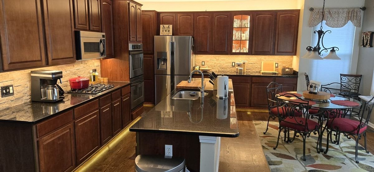 Kitchen with warm under-cabinet, toe-kick, and cove lighting
