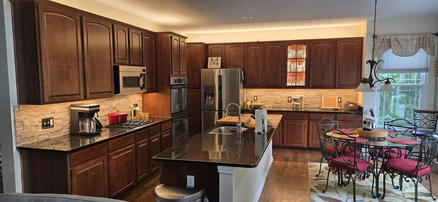 Kitchen with under-cabinet, glass-cabinet, and cove lighting on