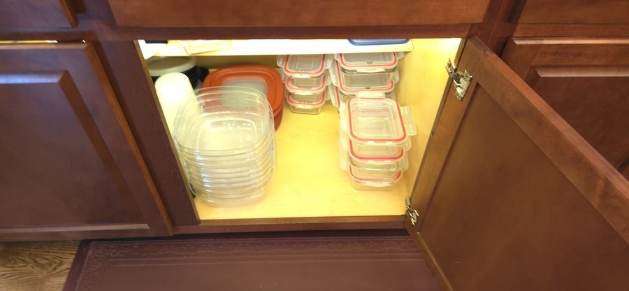 Open base cabinet with an interior LED strip lighting the shelves